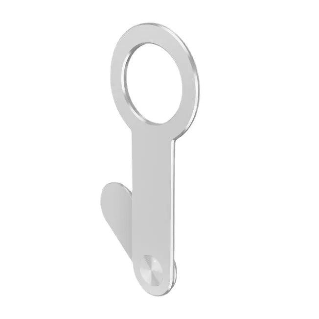Silver aluminium alloy magnetic extension holder for mobile phones on a desktop.