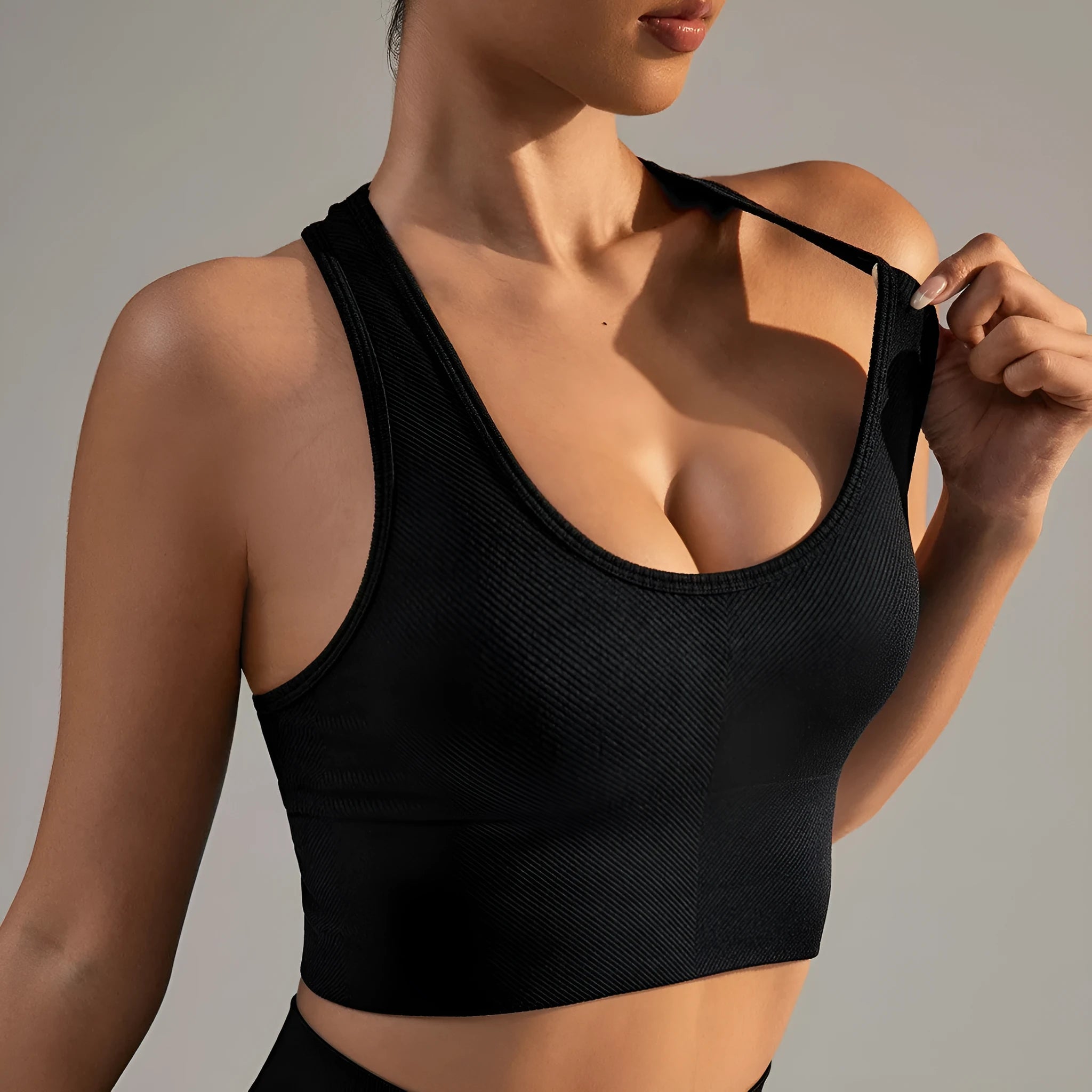 Black women's sports bra with cross back design for running and yoga