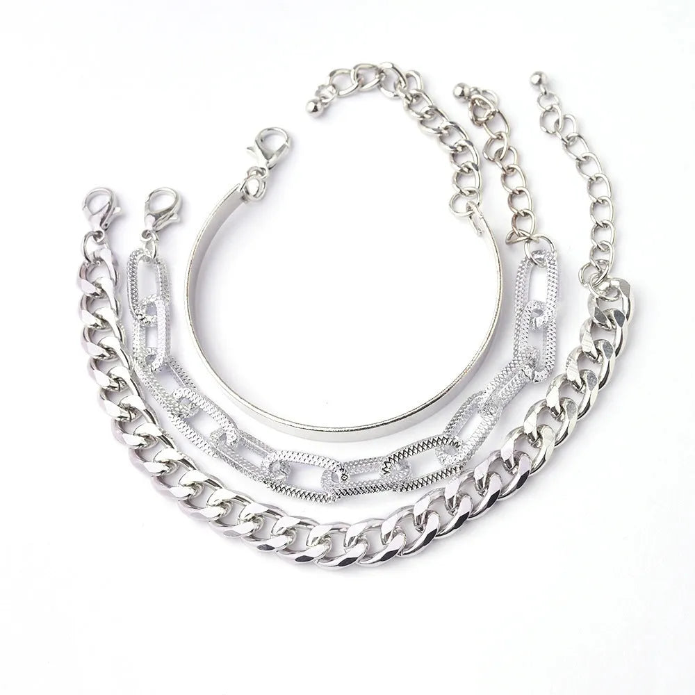 Set of 6 women's stretch bracelets with natural glass stones and gold beads arranged on a white surface