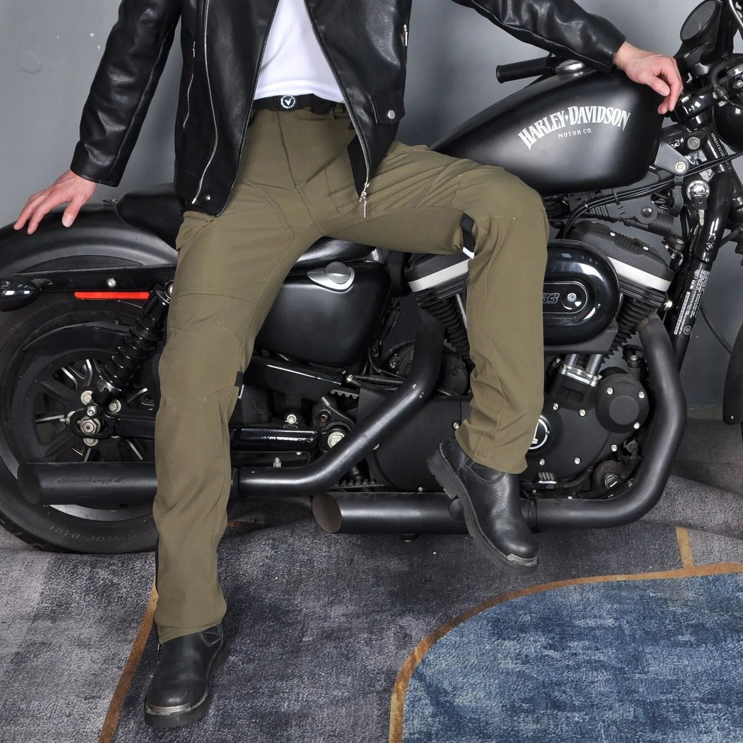Men's waterproof black motorcycle cycling pants with detachable belt and protective knee pads on a mannequin.