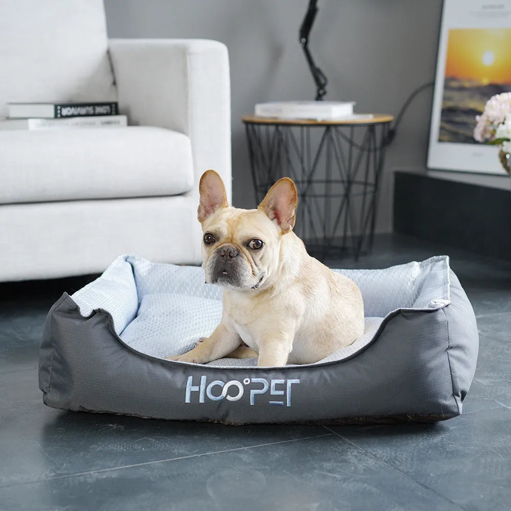Soft grey dog bed with raised edges and a removable plush cover, shown in medium size.