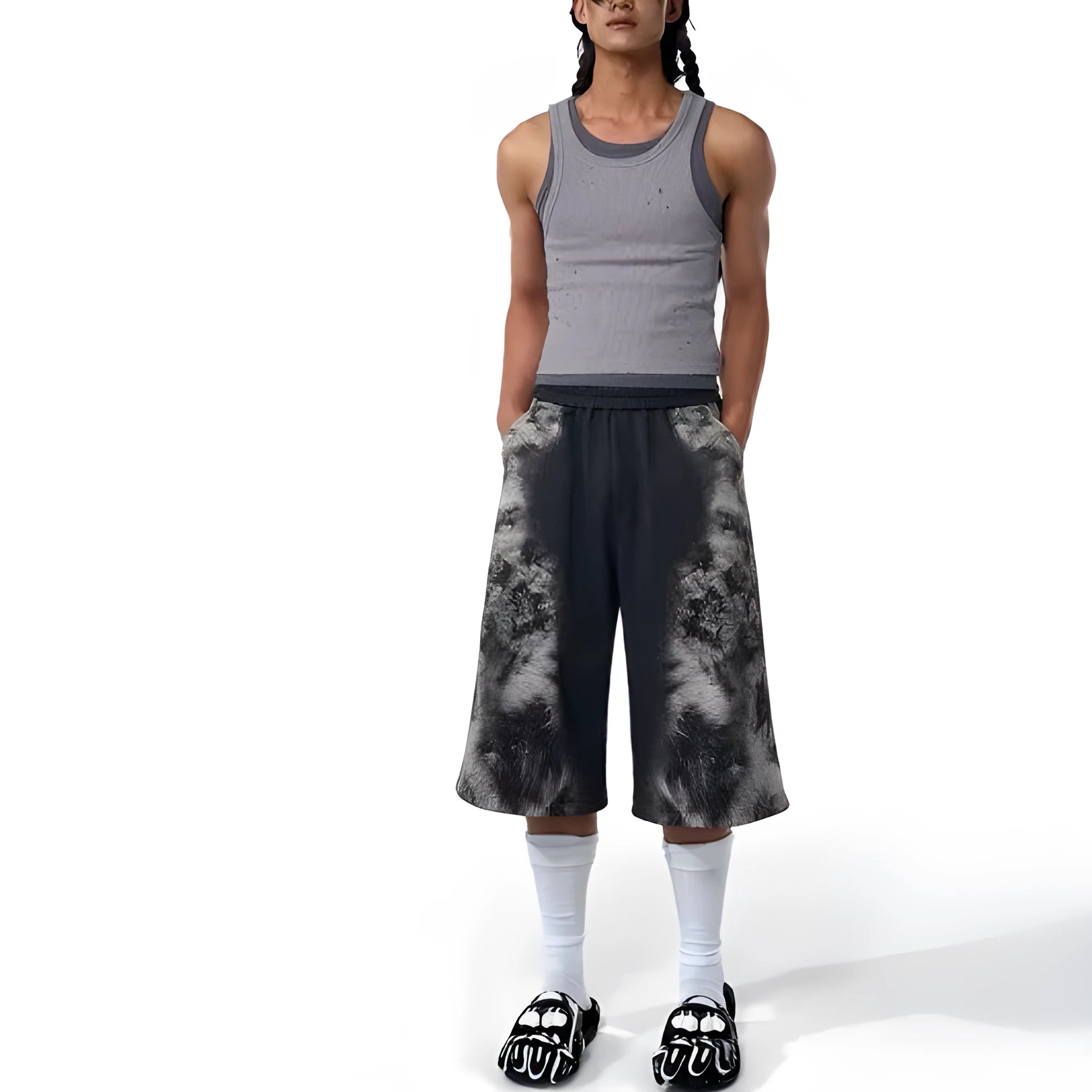 Woman wearing a loose-fit printed collage trouser and matching hoodie from a streetwear set.