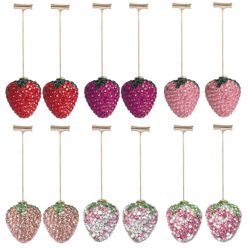 Geometric zinc alloy women's earrings with a red strawberry charm on a white background.