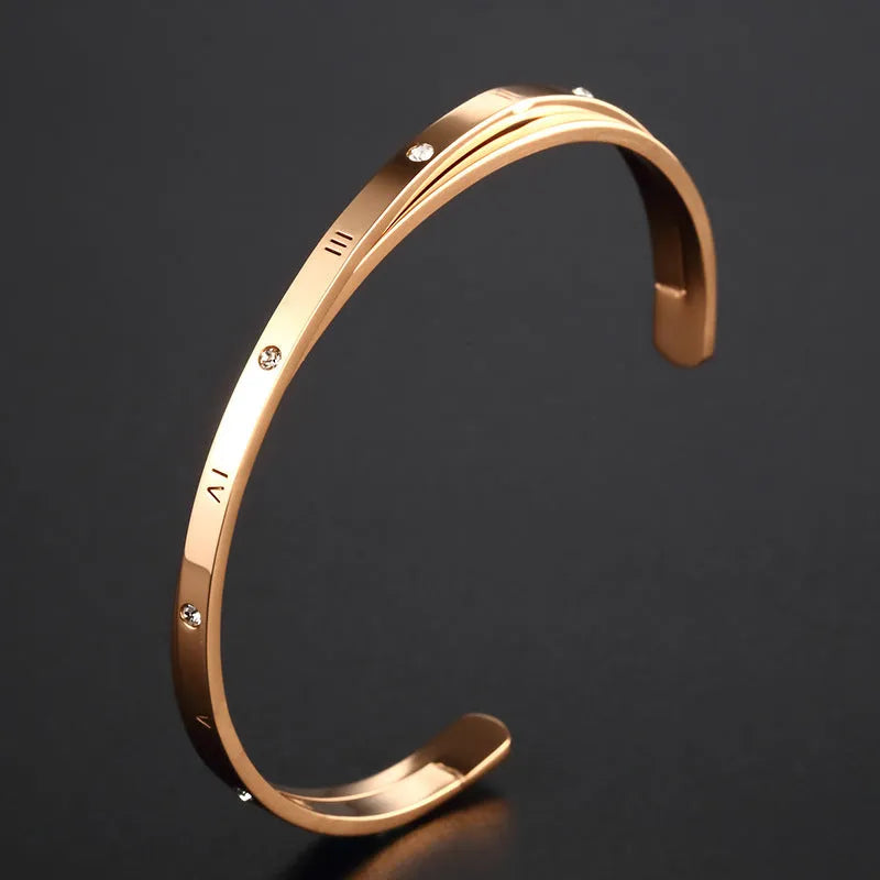 Open-ended adjustable ladies bracelet in stainless steel with zircon detailing showing gold colour finish