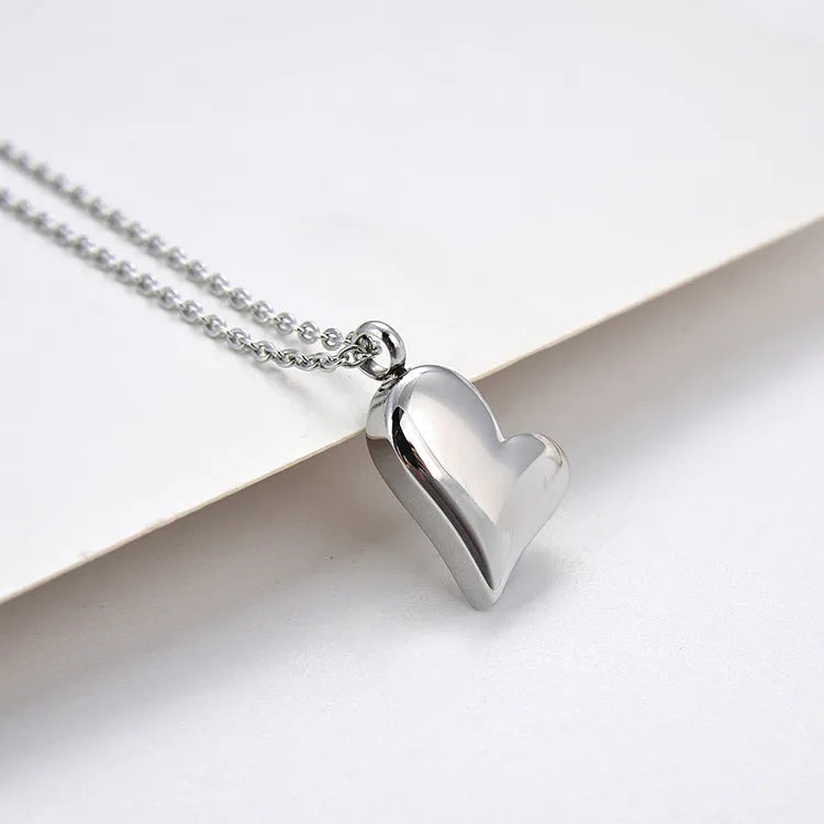 Curved peach heart stainless steel pendant necklace with silver electroplated finish on 51cm chain