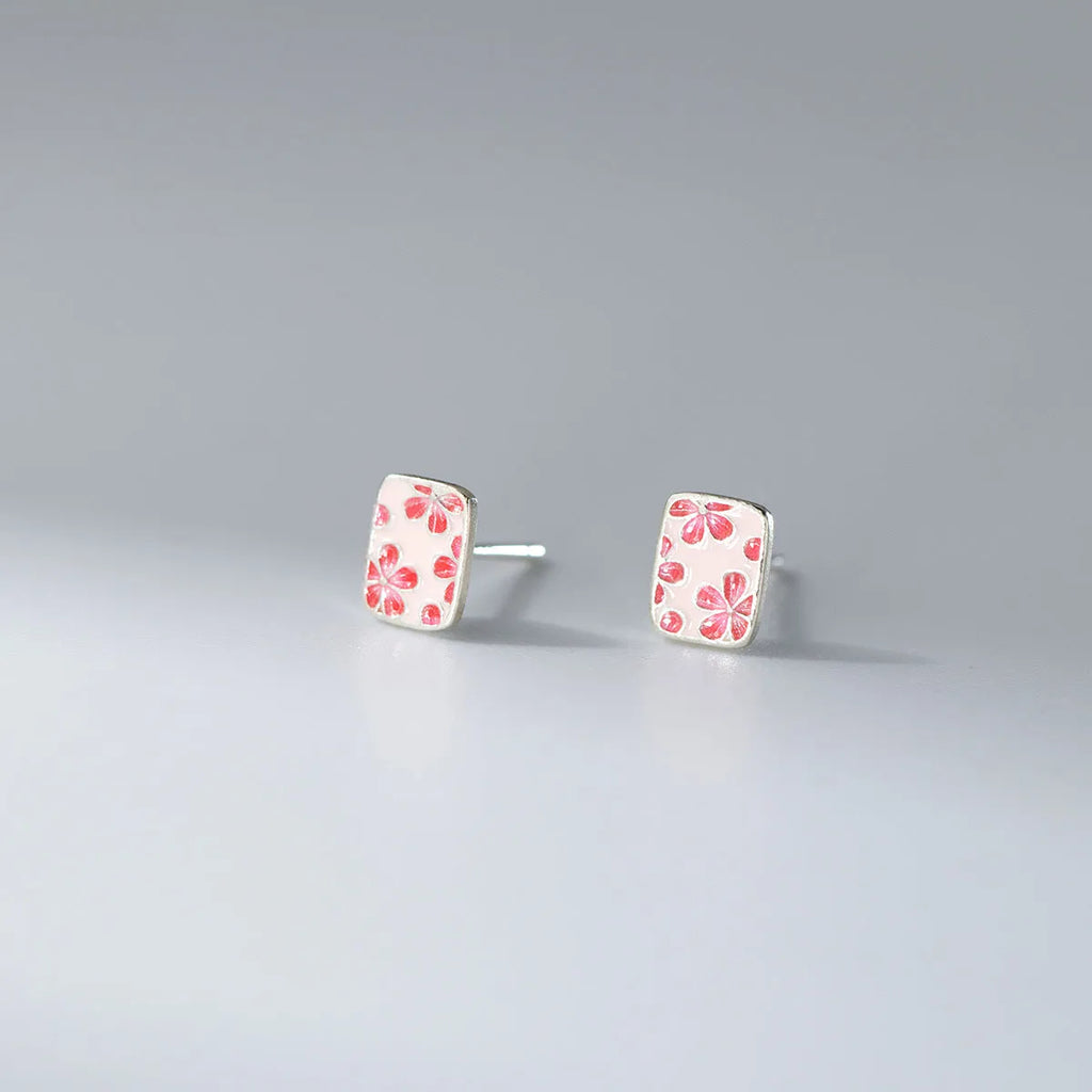 S925 sterling silver cherry blossom square stud earrings on a white background, showing polished silver finish and floral geometric design.