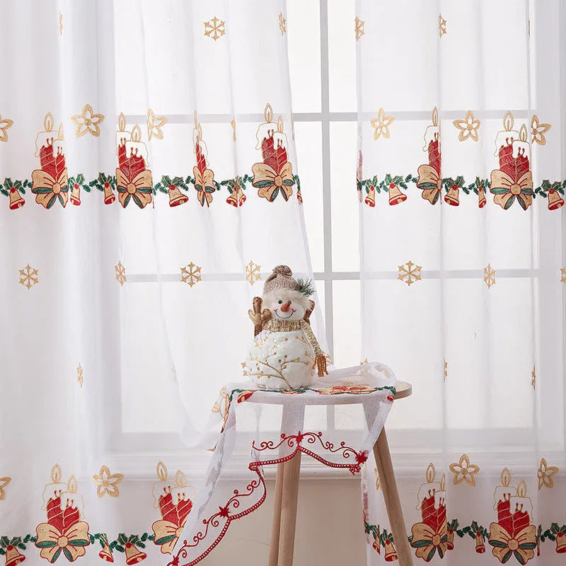 Pair of white polyester Christmas curtains with embroidered red snowflake design hung on a window