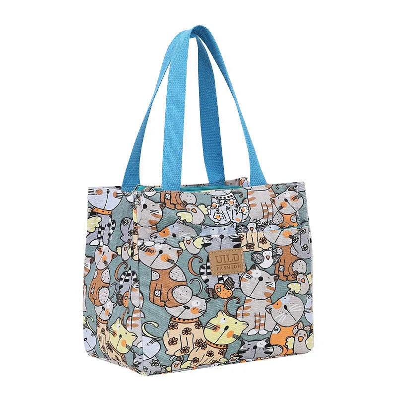 Women's printed canvas tote bag with aluminium hardware in a choice of floral and cat designs.