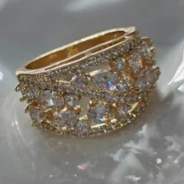 Women's copper hollow round fashion ring in gold or platinum with white or blue accent, shown on a hand.