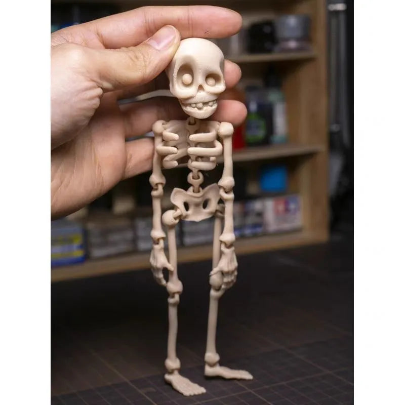 3D printed white skull refrigerator magnet ornament, 18cm tall, on a fridge door.