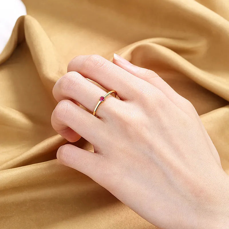 Geometric copper women's ring with a single diamond, shown in blue, green, red, and white colour variations.
