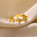Geometric titanium steel women's ring with golden diamond finish showing adjustable free-size design