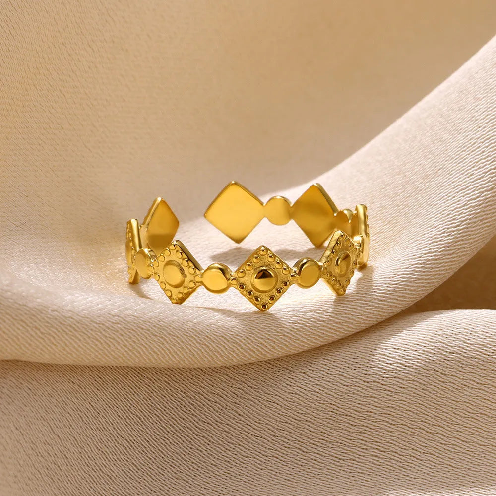 Geometric titanium steel women's ring with golden diamond finish showing adjustable free-size design