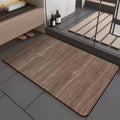 Square diatomite bathroom floor mat with wood grain geometric pattern on a tiled floor.