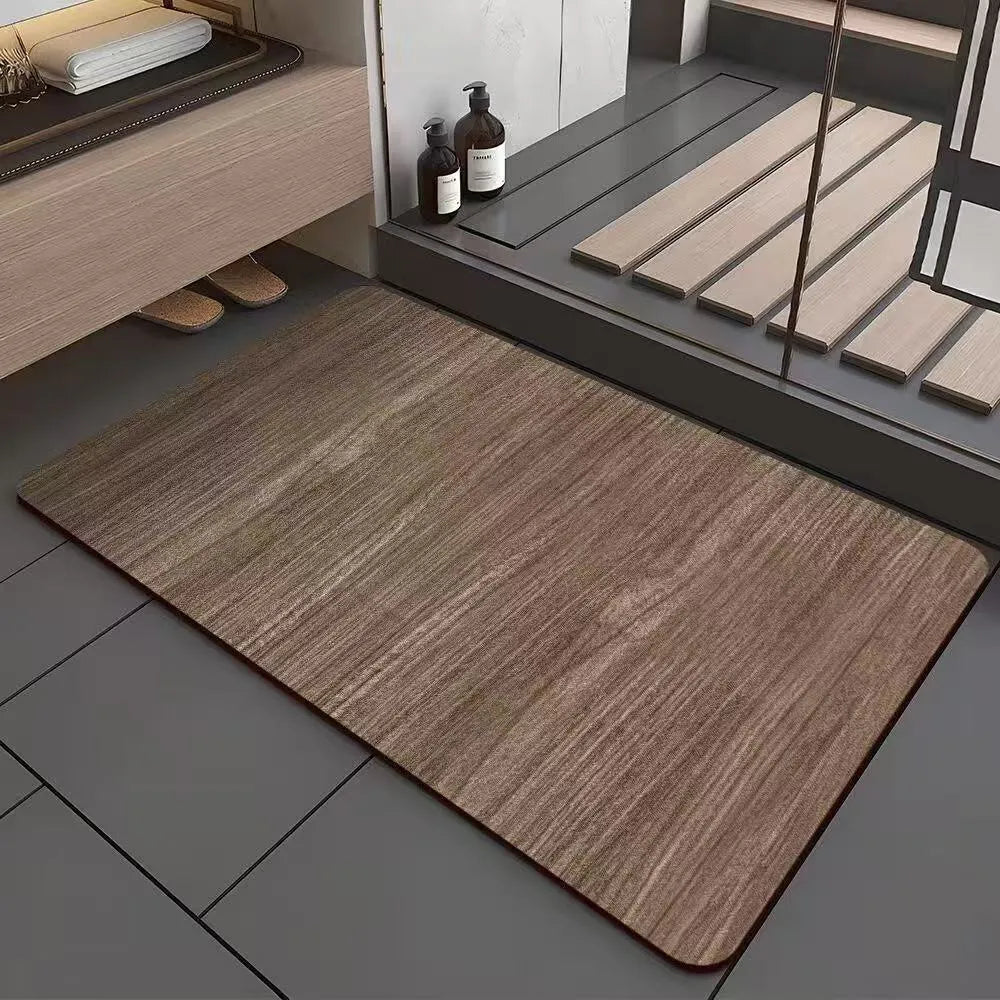 Square diatomite bathroom floor mat with wood grain geometric pattern on a tiled floor.