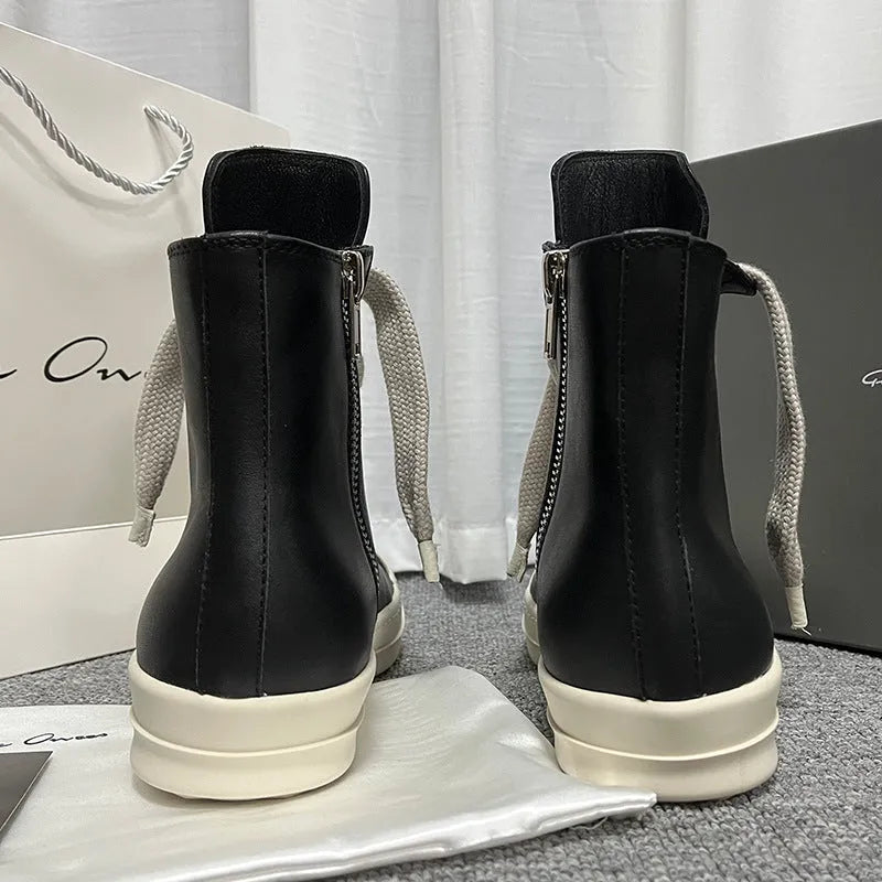 Black high-top leather sneaker boots with a side zipper and a thick rubber platform sole.