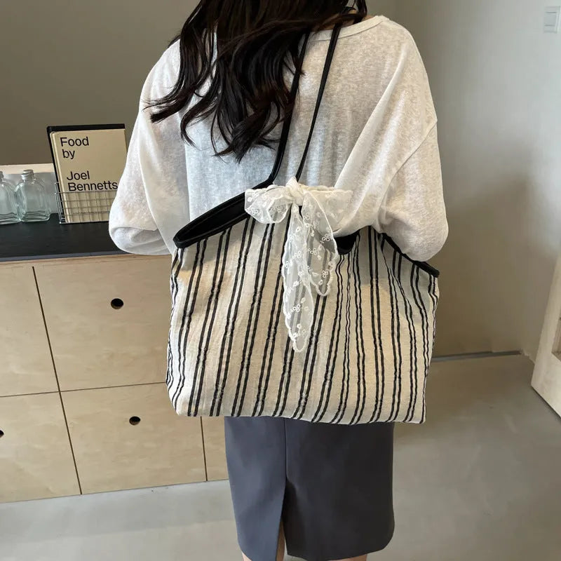 Striped cloth Korean style bucket shoulder messenger bag with beige ribbon scarf and woven belt detailing, soft horizontal square shape
