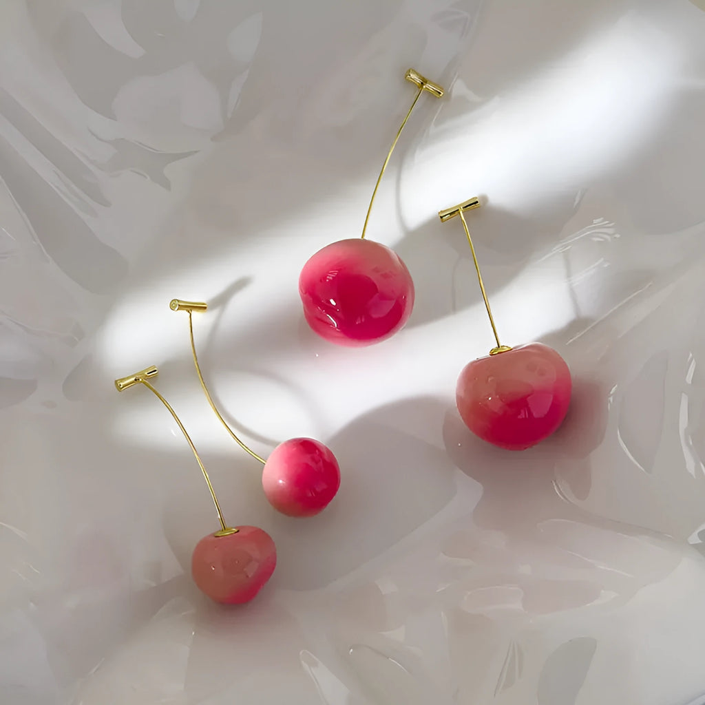 A pair of colourful acrylic peach-shaped stud earrings on a copper post, shown in small and large size options.