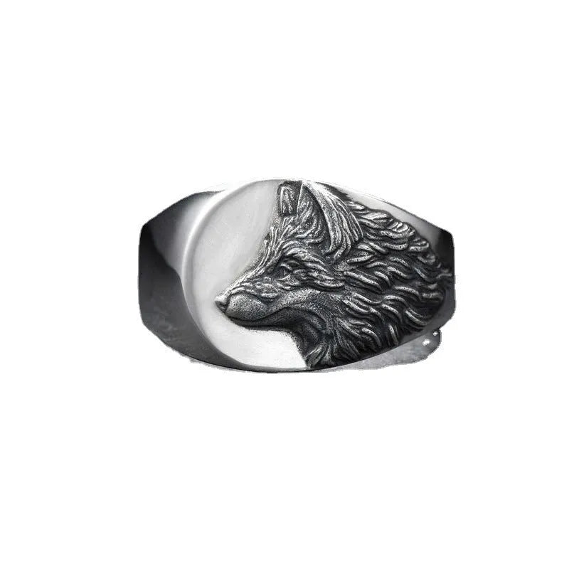 Silver geometric wolf head ring for men on a grey background.