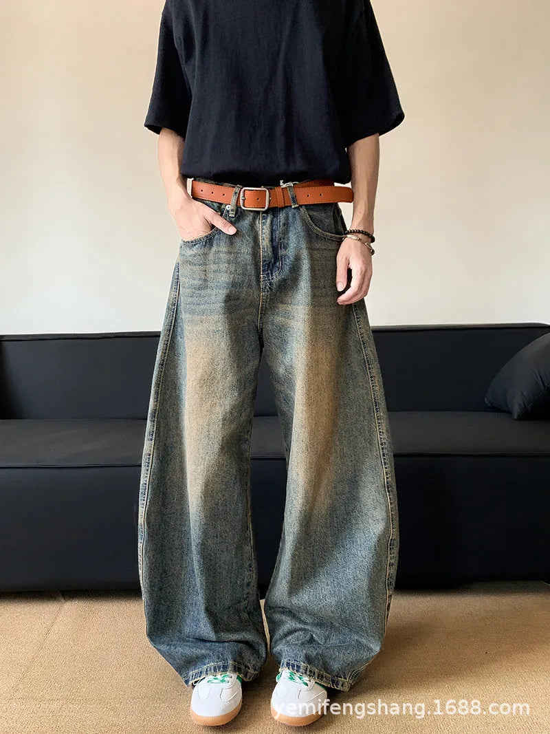Men's retro blue distressed denim jeans with a slimming wide-leg fit and machete wash detail.