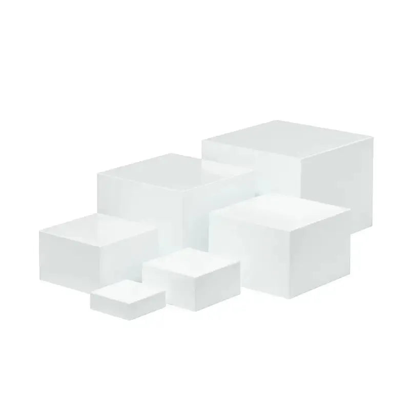 White plastic modular cube set assembled as a tiered desktop dessert display stand.