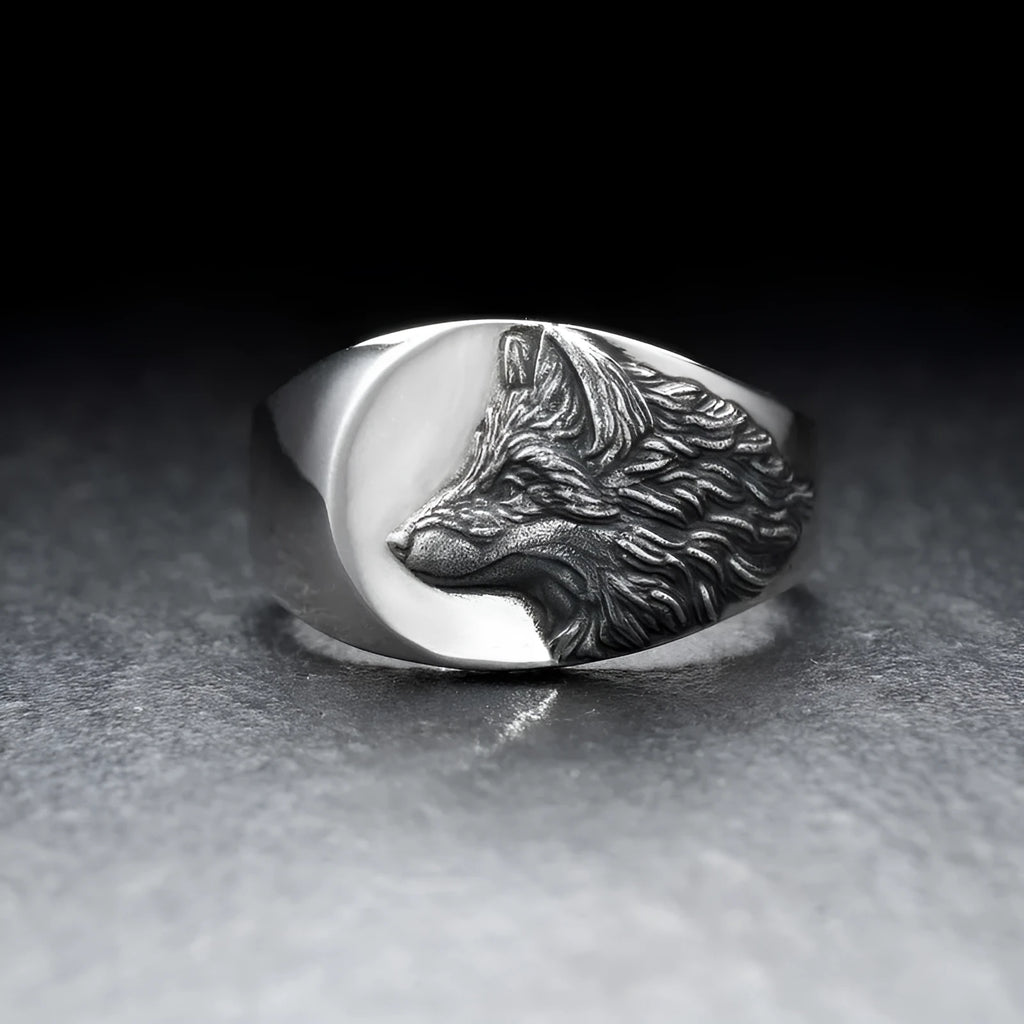 Silver geometric wolf head ring for men on a grey background.