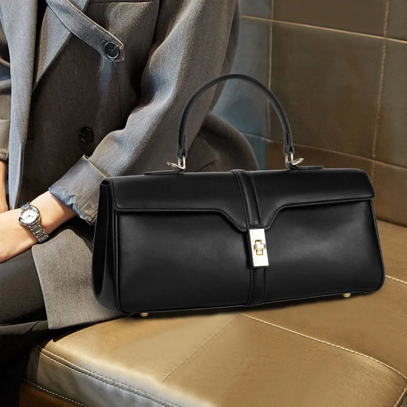 Women's genuine cowhide messenger bag in cylindrical shape with internal organisers