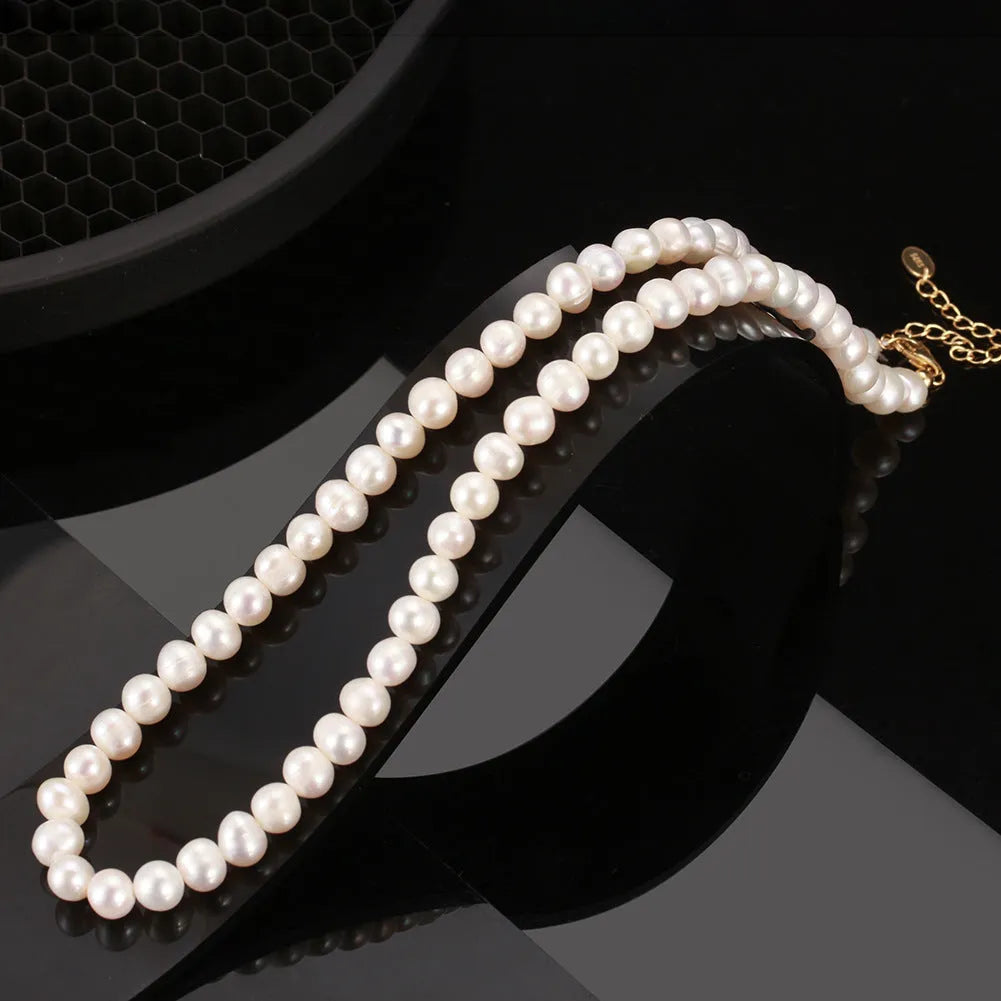 Women's silver adjustable chain necklace with a single natural freshwater pearl.