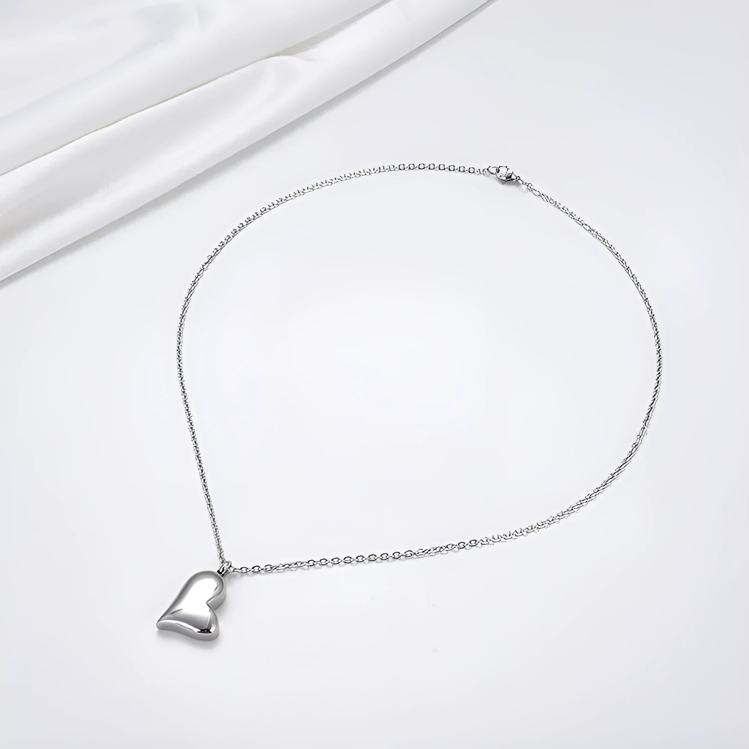 Curved peach heart stainless steel pendant necklace with silver electroplated finish on 51cm chain
