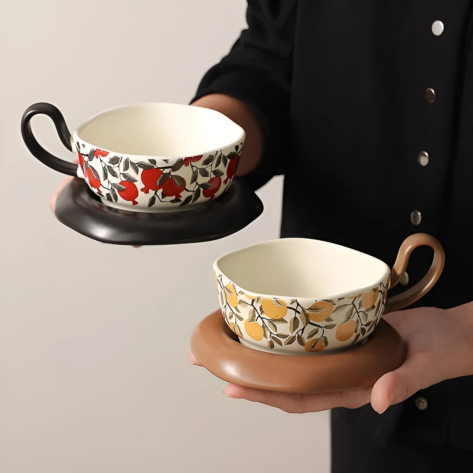 Antique style ceramic coffee cup and saucer set with medieval botanical print in black or orange.