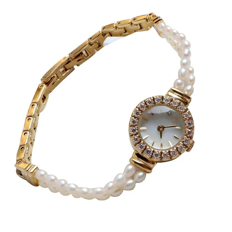 Light gold women's bracelet watch with freshwater pearls, round dial, and stainless steel strap