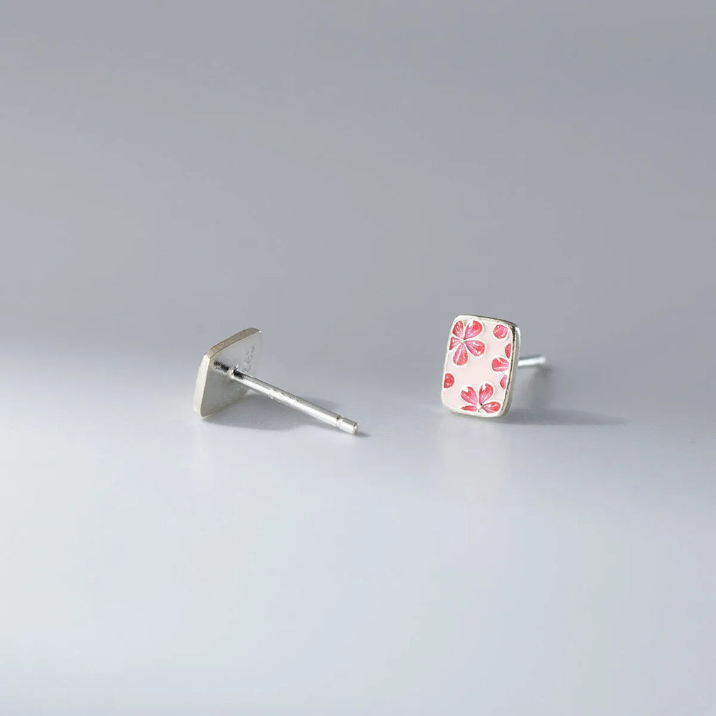 S925 sterling silver cherry blossom square stud earrings on a white background, showing polished silver finish and floral geometric design.