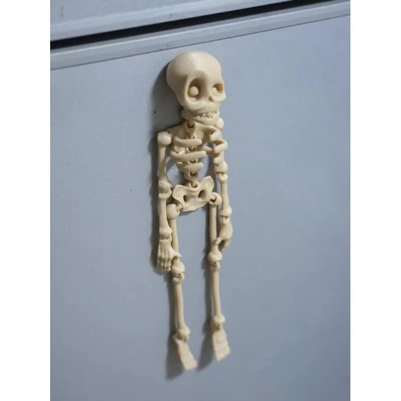 3D printed white skull refrigerator magnet ornament, 18cm tall, on a fridge door.