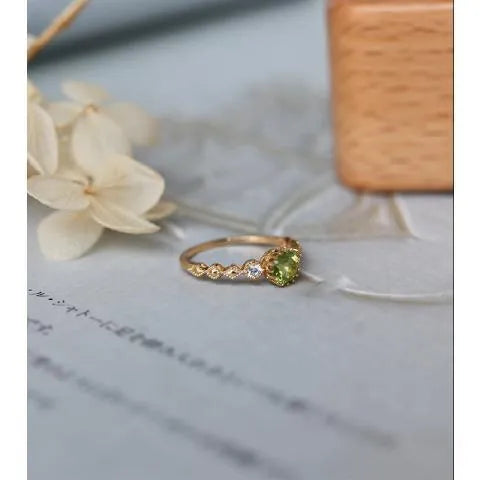 Copper women's ring with a green geometric quadrilateral stone in a Japanese style design.
