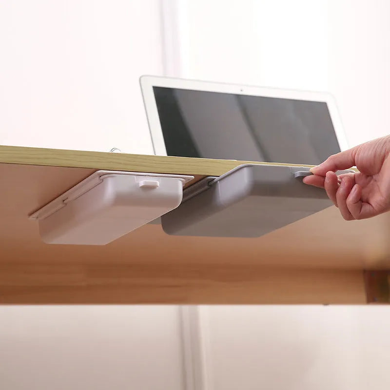 White plastic adhesive under-table storage drawer with covered lid and internal grid compartments