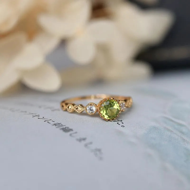 Copper women's ring with a green geometric quadrilateral stone in a Japanese style design.