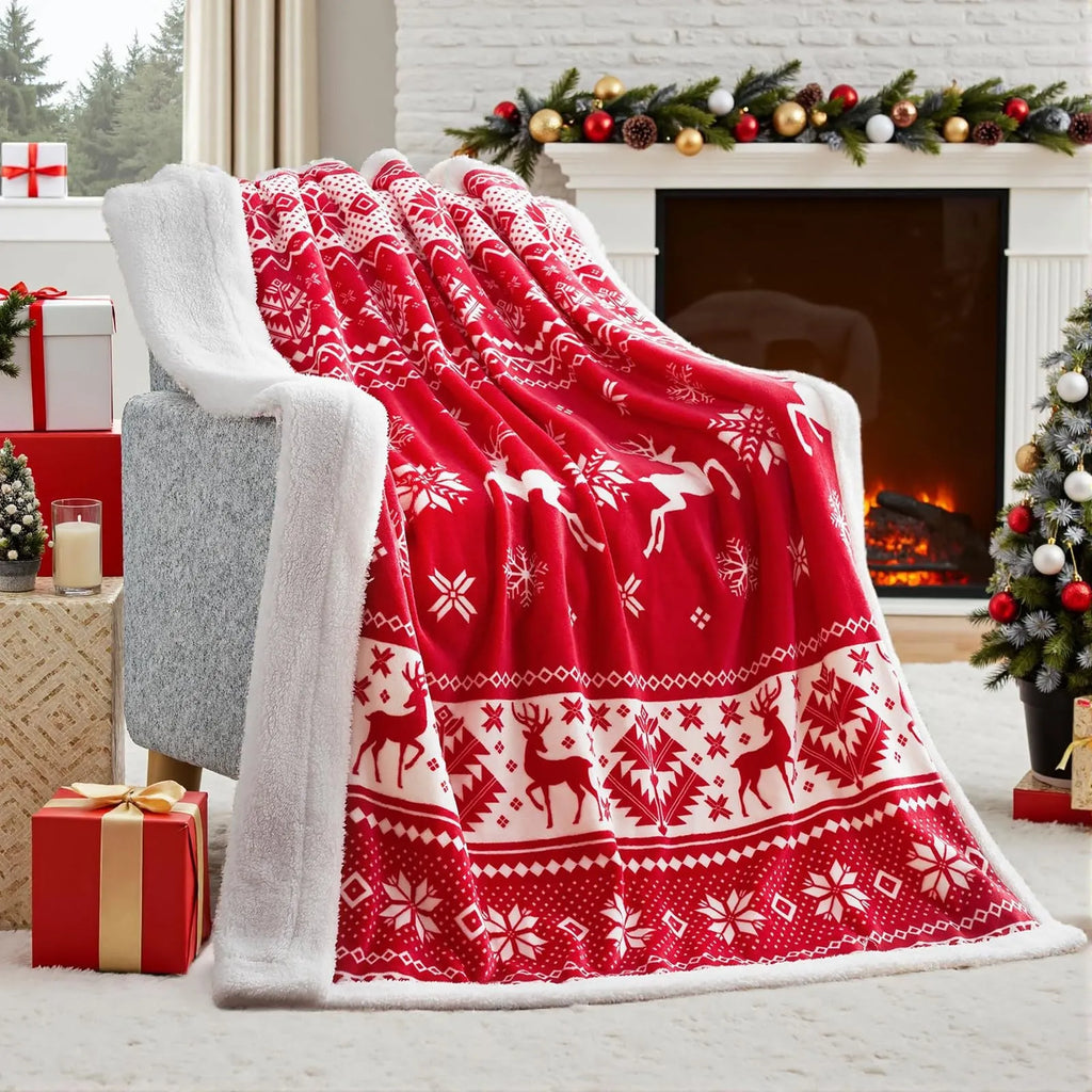 Reversible soft flannel Christmas blanket in a selection of colours and sizes on a sofa.
