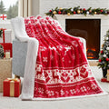 Reversible soft flannel Christmas blanket in a selection of colours and sizes on a sofa.