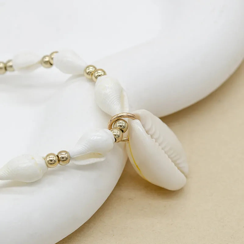 White conch bead necklace with a mother-of-pearl shell pendant on a regular chain