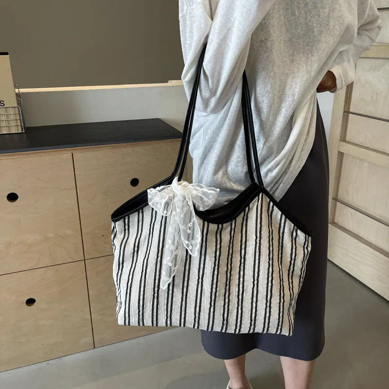 Striped cloth Korean style bucket shoulder messenger bag with beige ribbon scarf and woven belt detailing, soft horizontal square shape