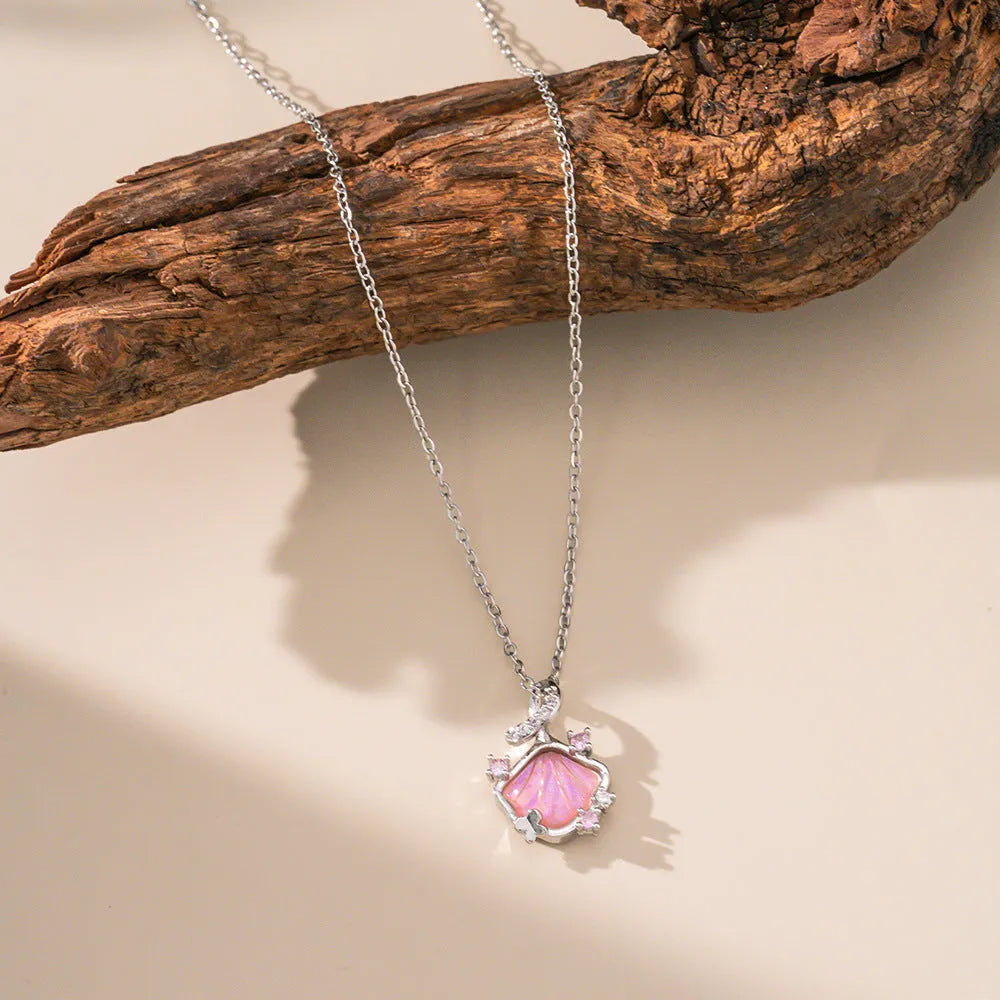 Geometric shell pendant necklace with electroplated copper pendant on stainless steel O-shaped chain, close-up view
