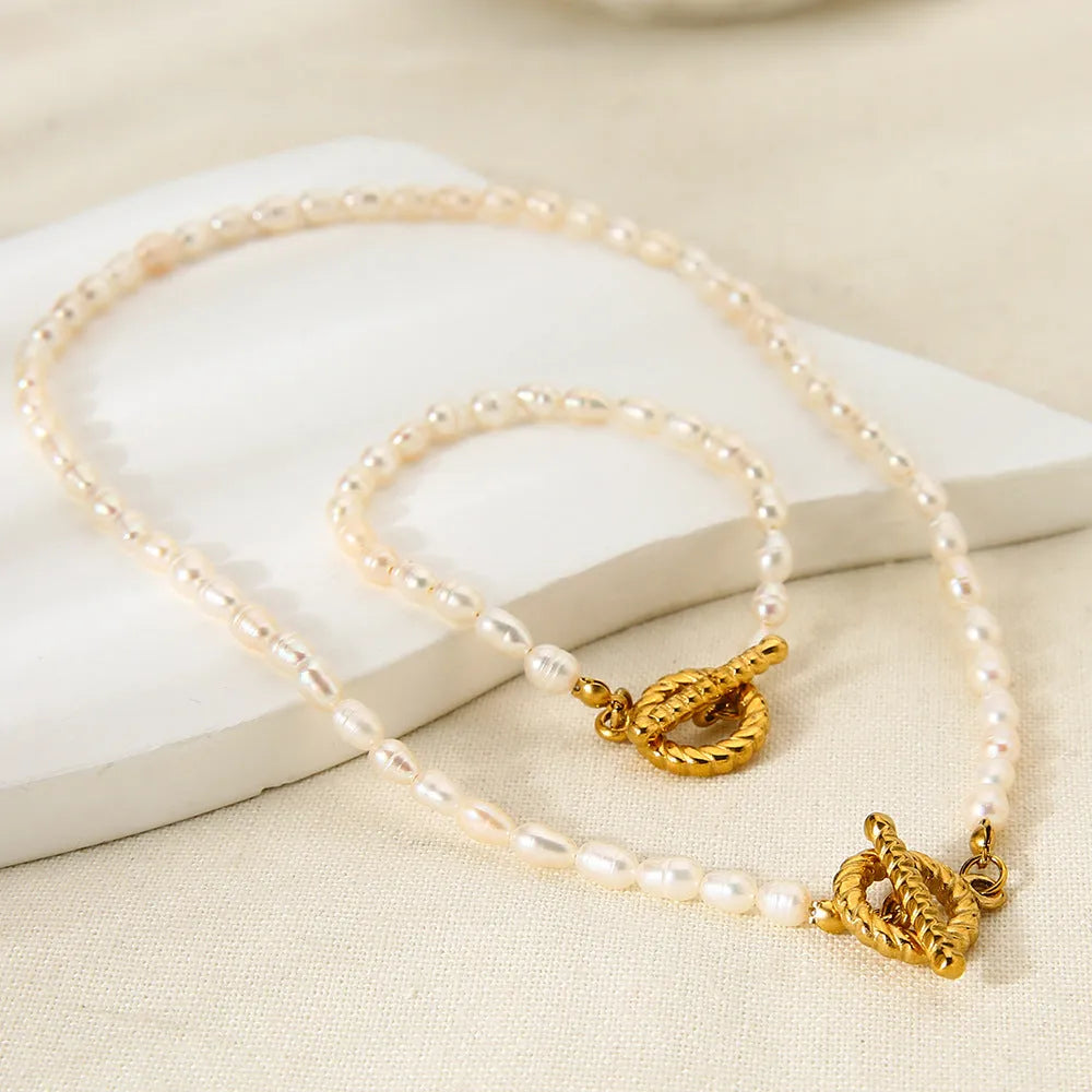 Freshwater pearl and stainless steel necklace bracelet set with geometric shapes on clavicle chain