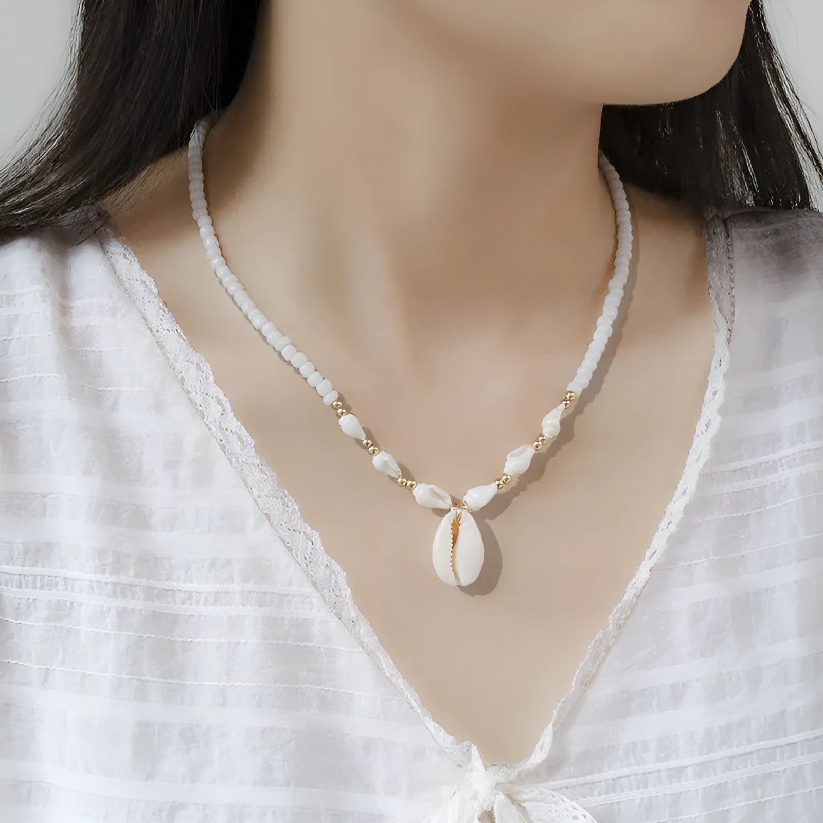 White conch bead necklace with a mother-of-pearl shell pendant on a regular chain