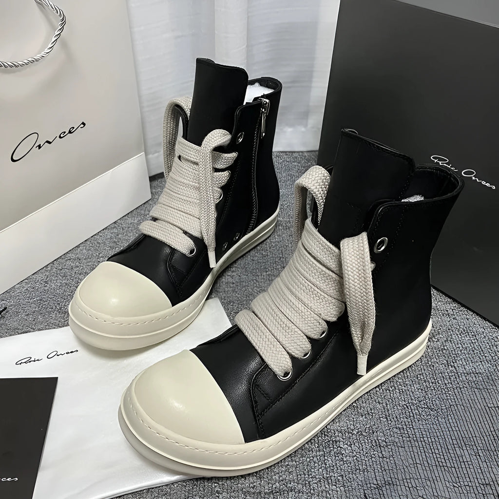 Black high-top leather sneaker boots with a side zipper and a thick rubber platform sole.