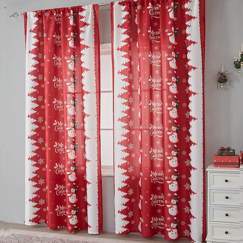 Rectangular printed polyester curtain with festive design hanging in a window