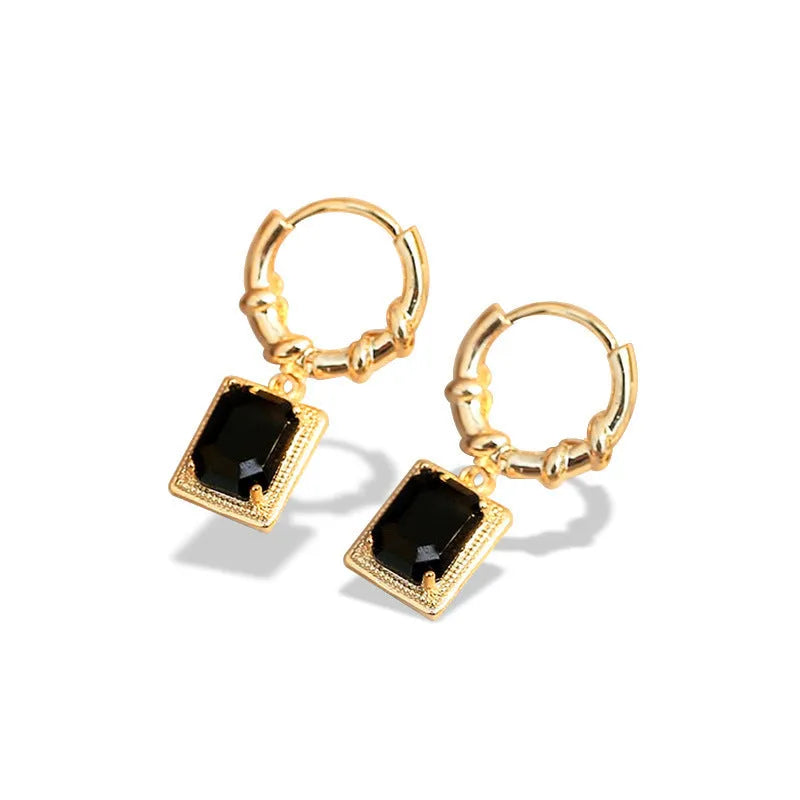 A pair of square geometric copper earrings with a black zircon in a French court retro setting.
