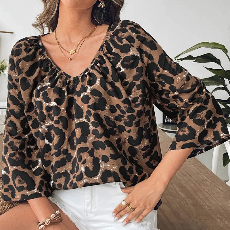 Women's multicolor leopard print polyester pullover top with V-neck and half sleeves.