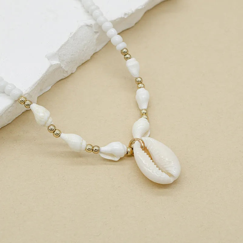 White conch bead necklace with a mother-of-pearl shell pendant on a regular chain