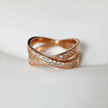 Simple silver cross ring with micro-inlaid zircon detail on a model's finger.