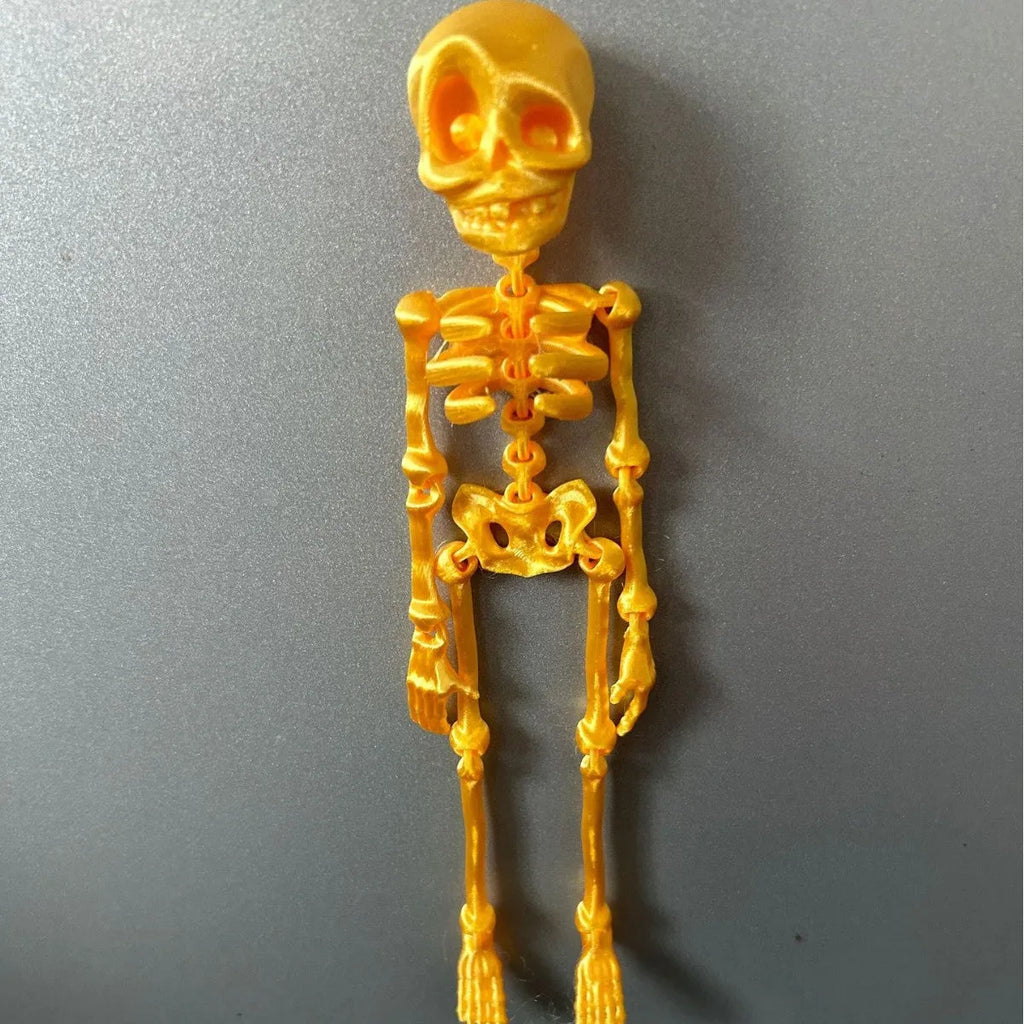 3D printed white skull refrigerator magnet ornament, 18cm tall, on a fridge door.